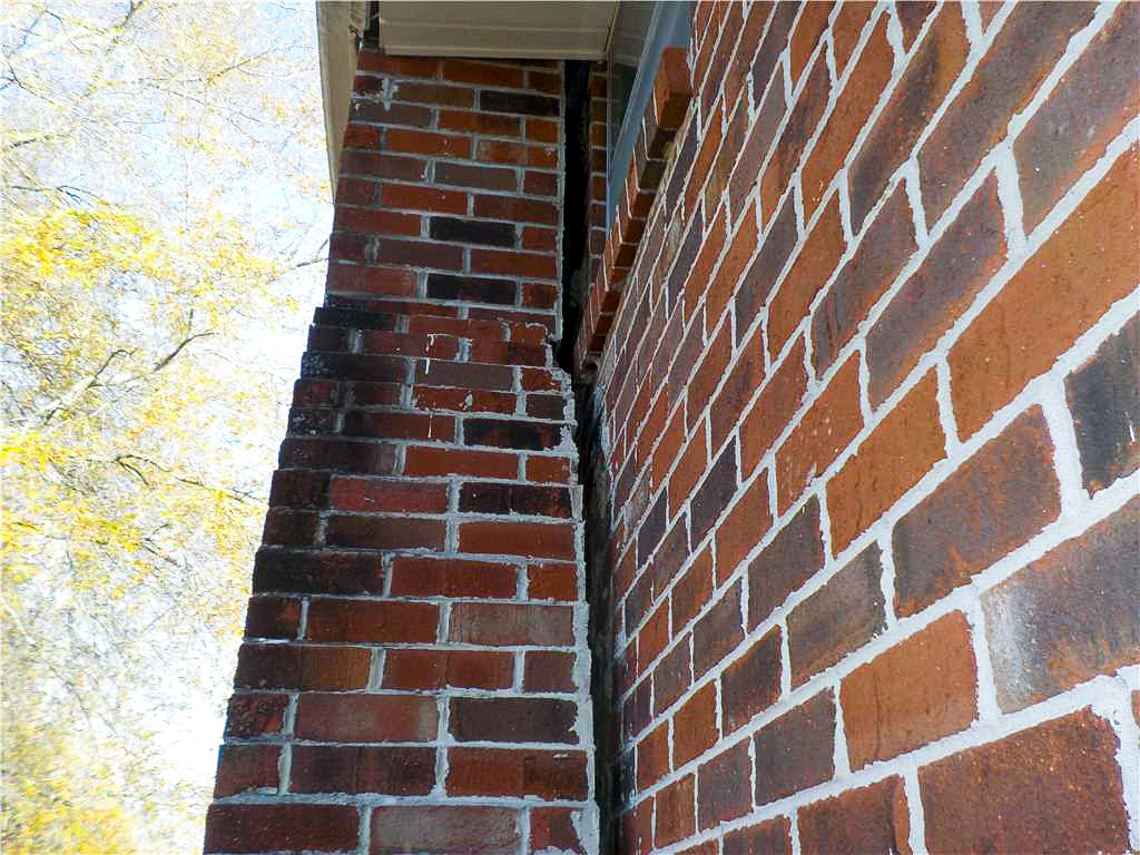 Chimney separating from home showing foundation issues